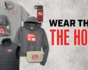 Promotional merch for 102.9 The Hog: hoodie, polo, beanie, vest, fanny pack, water bottle, all with the red station logo.