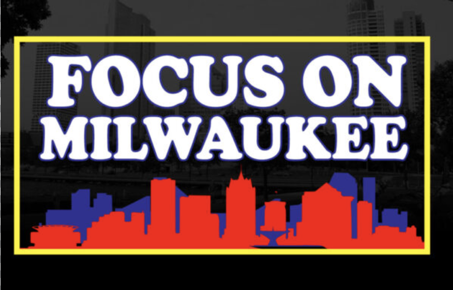 Poster-style sign reading 'FOCUS ON MILWAUKEE' with a red and blue city skyline silhouette inside a yellow frame.