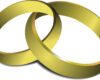 Two interlocking gold rings, symbolizing commitment or eternity on a white background.