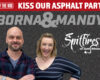 Promotional photo of a man and woman in front of a textured asphalt backdrop with 'Born & Mandy' and 'Spitfires on State Milwaukee' logos and the red 'Kiss Our Asphalt Party' banner at the top.