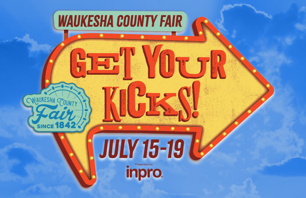 Bright yellow arrow sign advertising Waukesha County Fair with 'Get Your Kicks!' and July 15–19 against a blue sky.