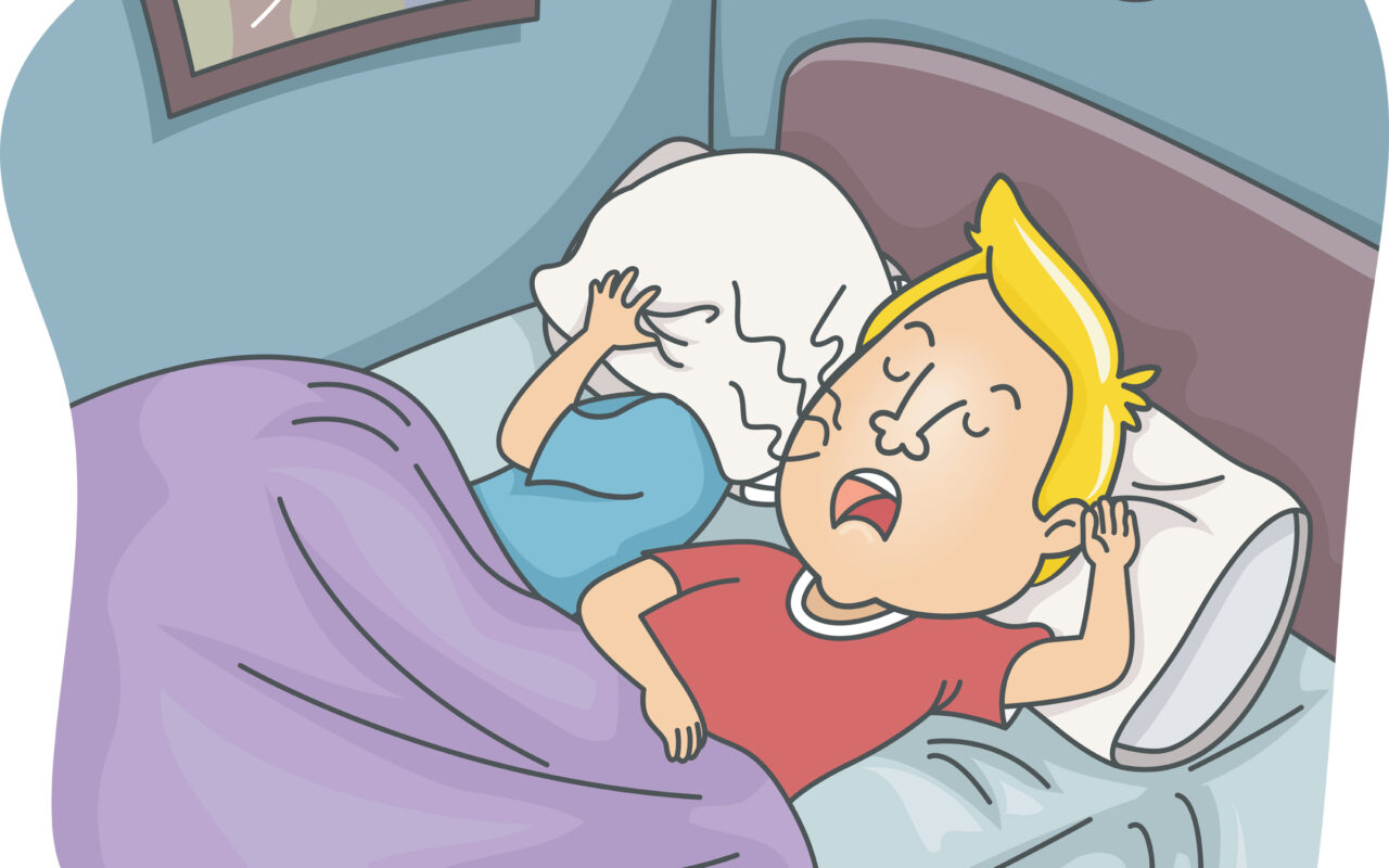 Two kids in bed; a blond-haired boy in a red shirt sits up and shouts while the other child hides under a pillow, covering their head with a pillow under a purple blanket.